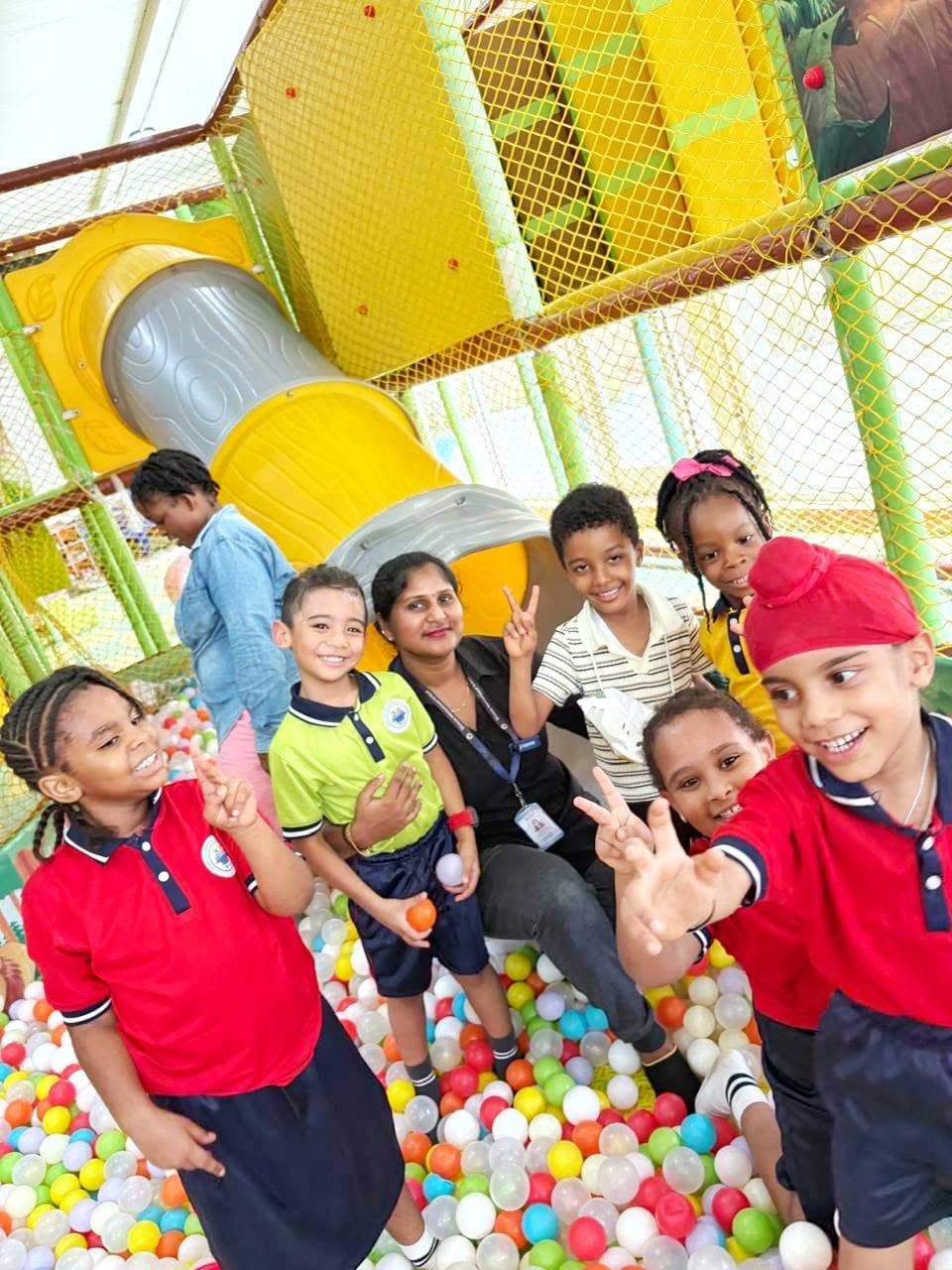 Young students playing in a ball pit on outing day